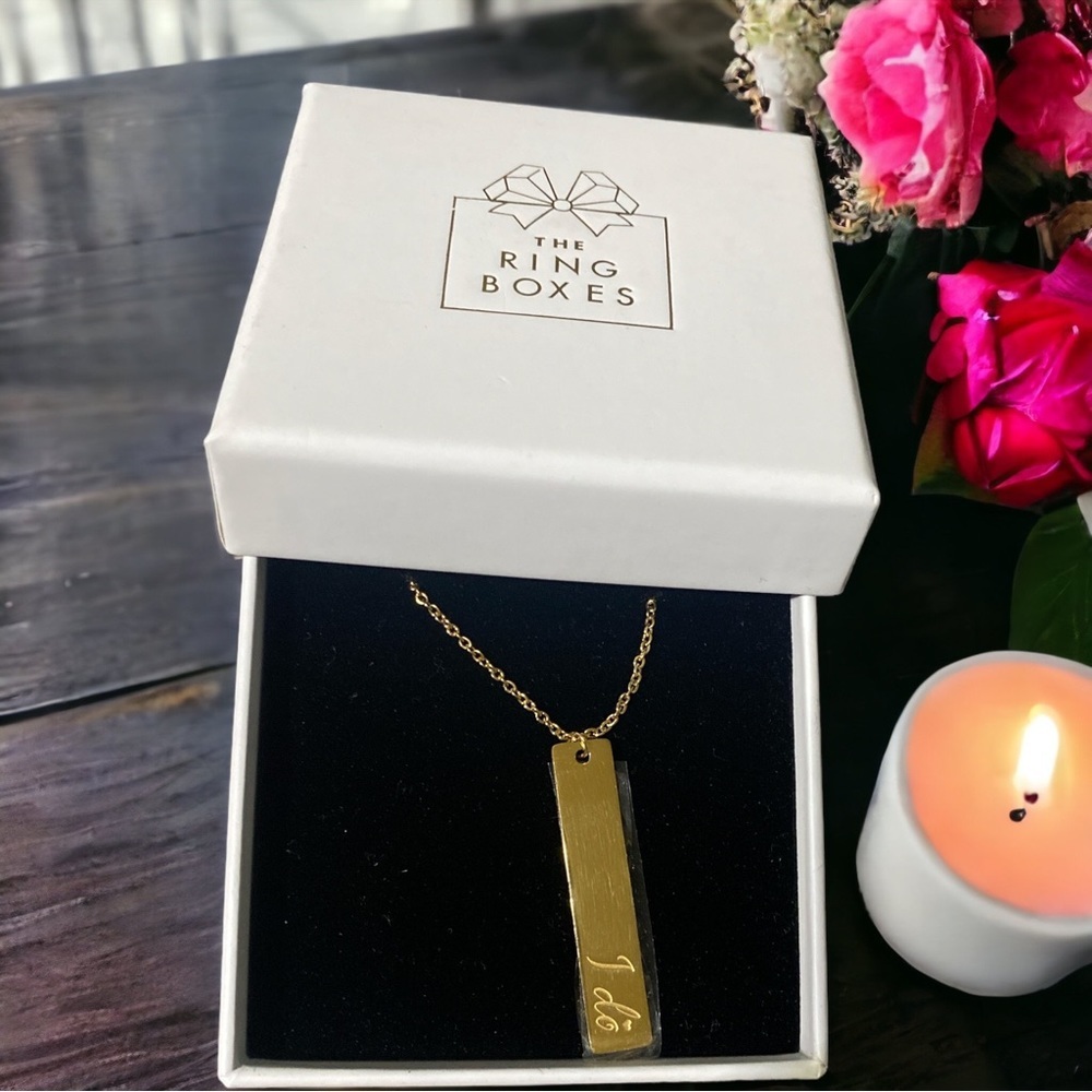 The Ring Boxes “I Do” engraved gold tone necklace.​